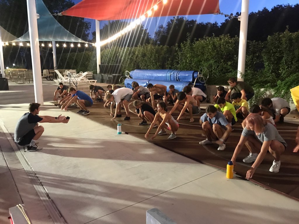 Coach Coppock leading dynamic stretching in the early morning